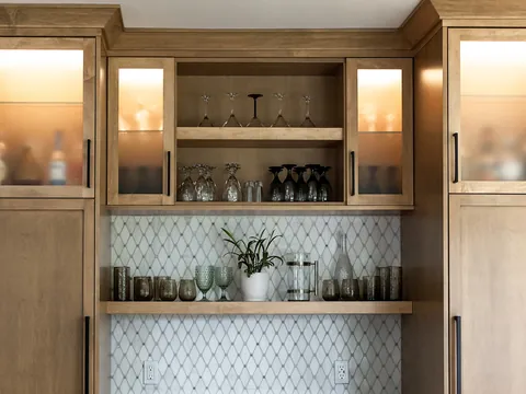 Custom cabinetry with glass-front uppers