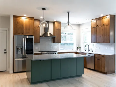 Kitchen with stained wood cabinets and a green island