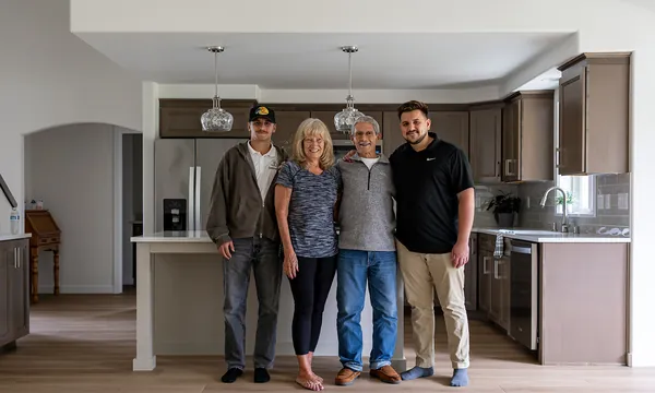 Homeowners with a JDI team member in their finished kitchen